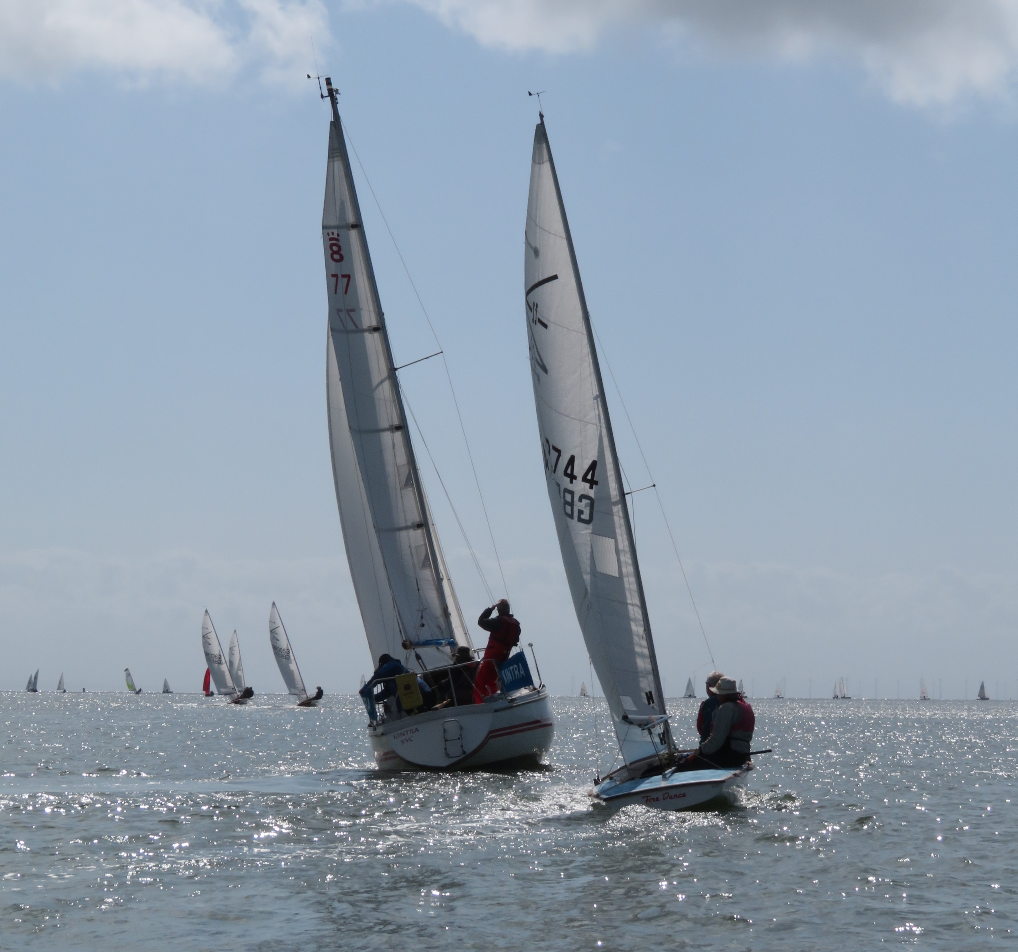 Sparkling seas on the RNLI Regatta day, John Searle and crew in “Kintra" with Ian Purkis and Pete Lee (Flying Fifteen) closing from astern, with the whole fleet ahead (Photo: John Sproat)